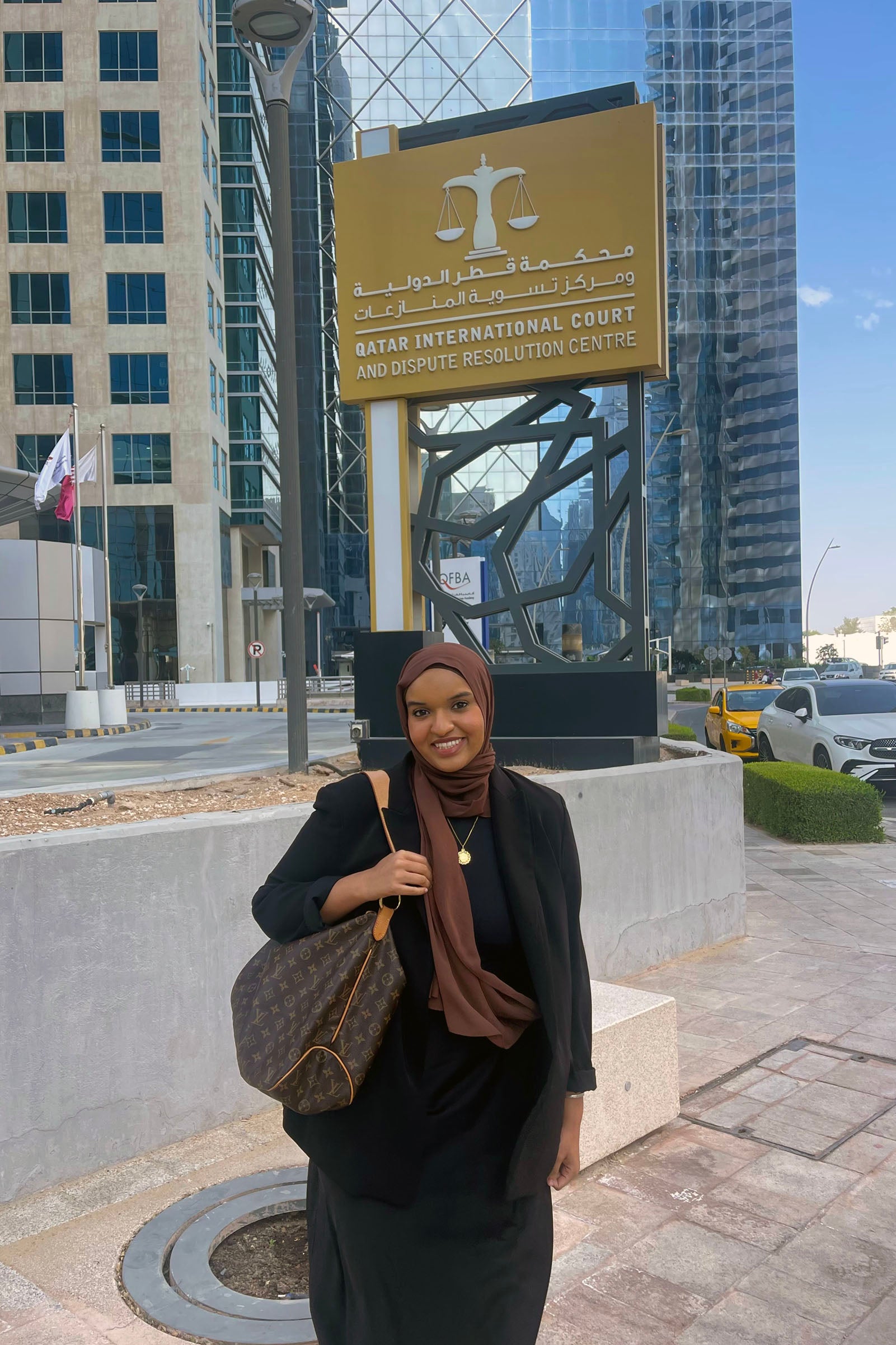 Malika Kounkourou in front of the Qatar International Court.