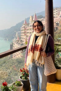 Abhi Nathan on a balcony overlooking a river.