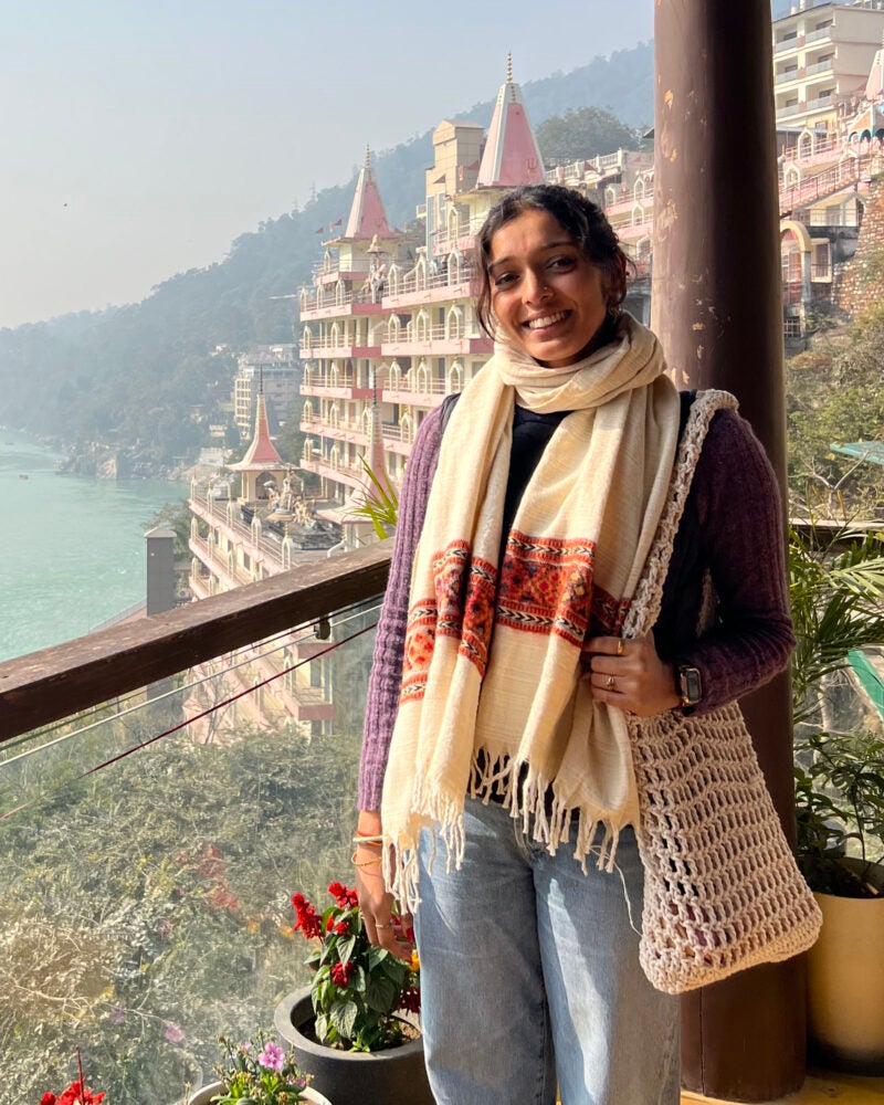 Abhi Nathan on a balcony overlooking a river.