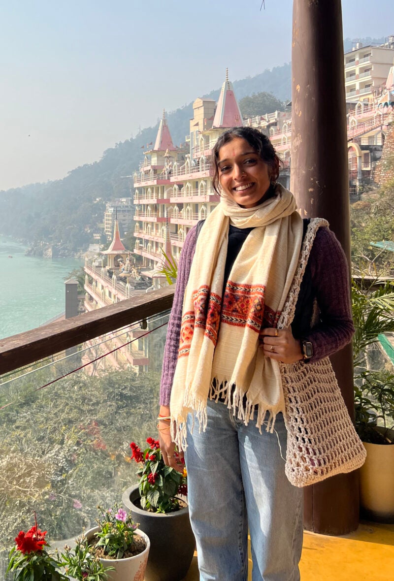 Abhi Nathan on a balcony overlooking a river.