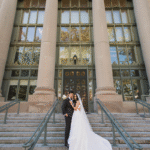 Bride and groom on steps of Langdell.