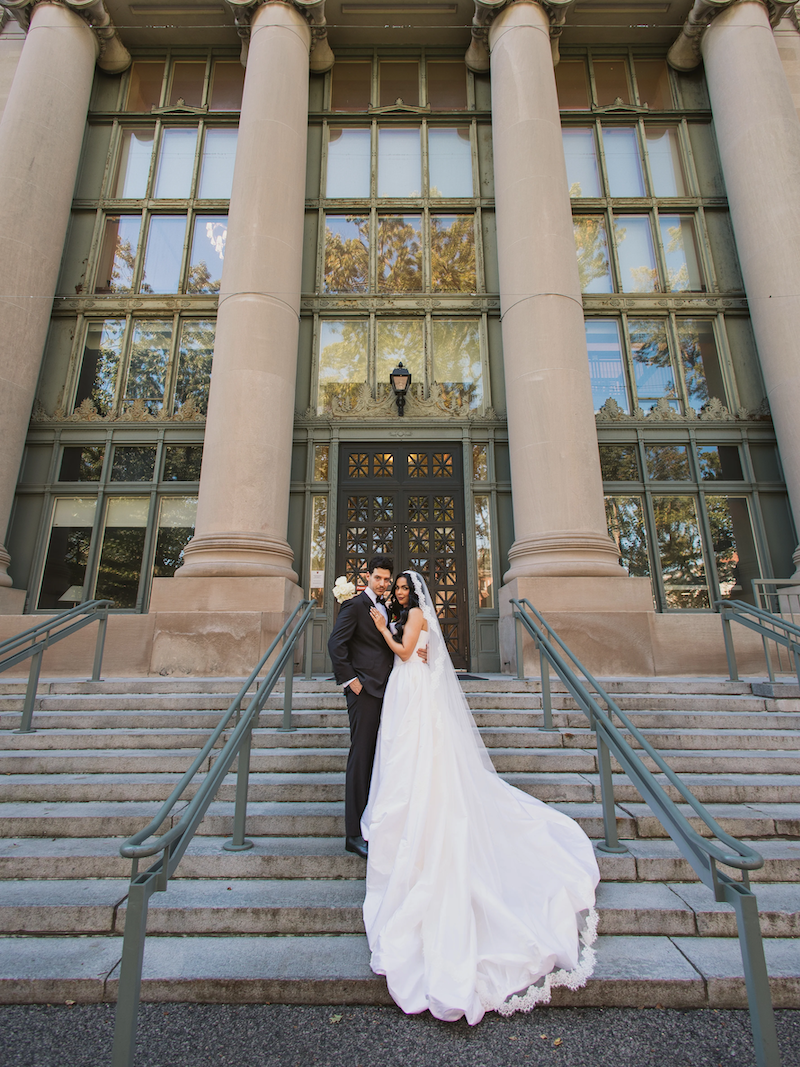 Bride and groom on steps of Langdell.