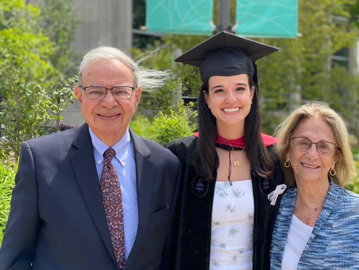 Stanley and Sandra Freshman Keller stand with their granddaughter at commencement