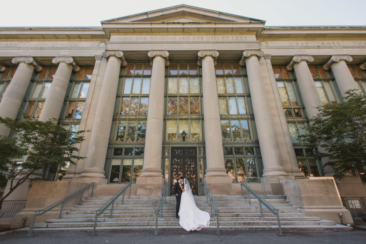 Bride and groom on steps of Langdell.