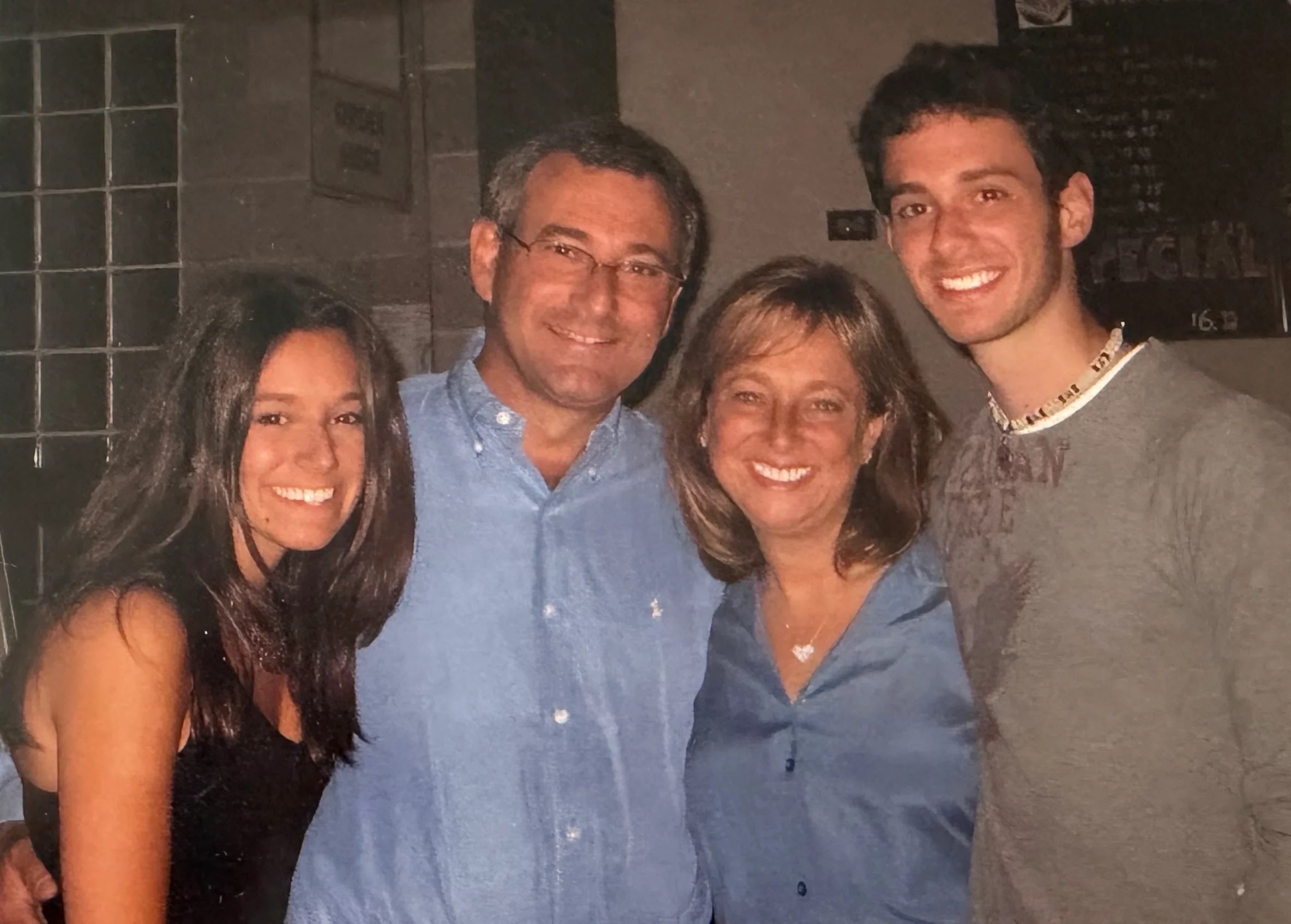 The Solows pose for photo with their two children.