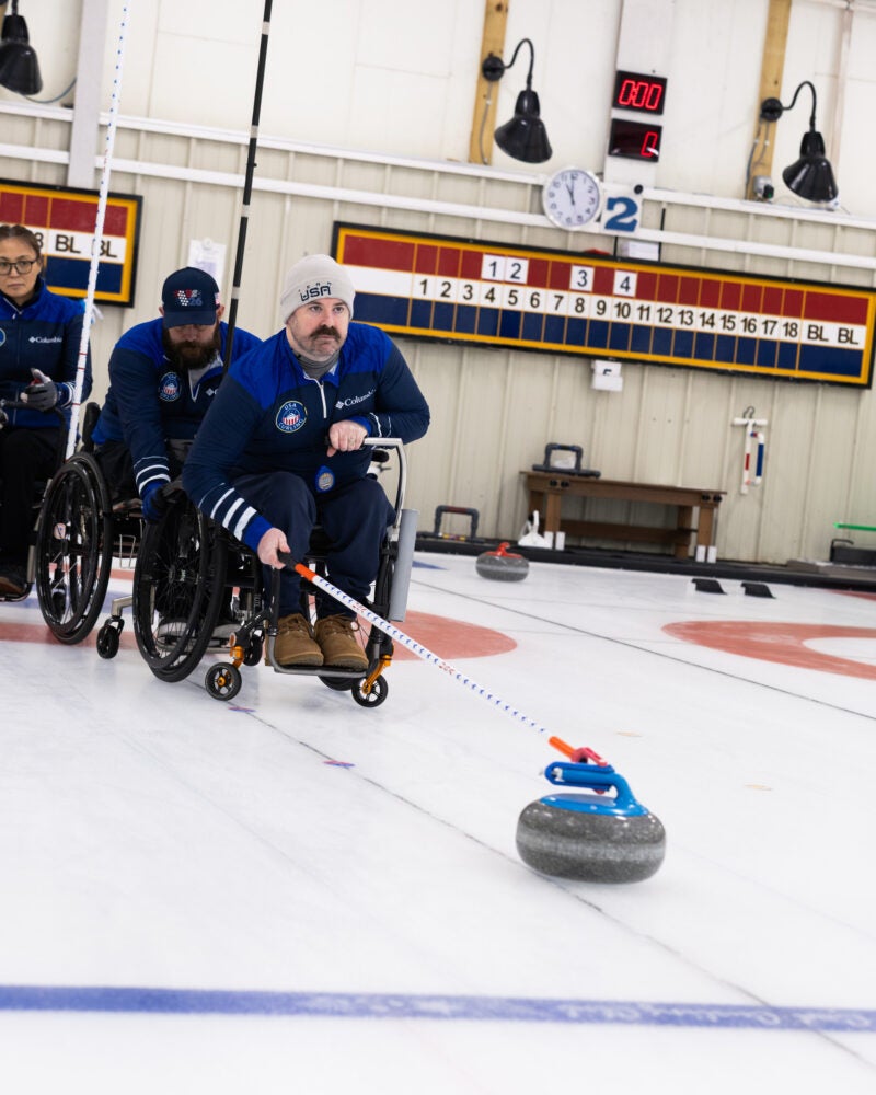 Sean O'Neill curling at the 2026 Paralympic Winter Games.