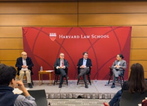 Four people speaking at HLS event.