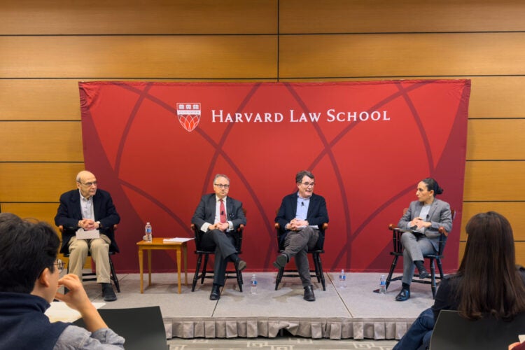 Four people speaking at HLS event.