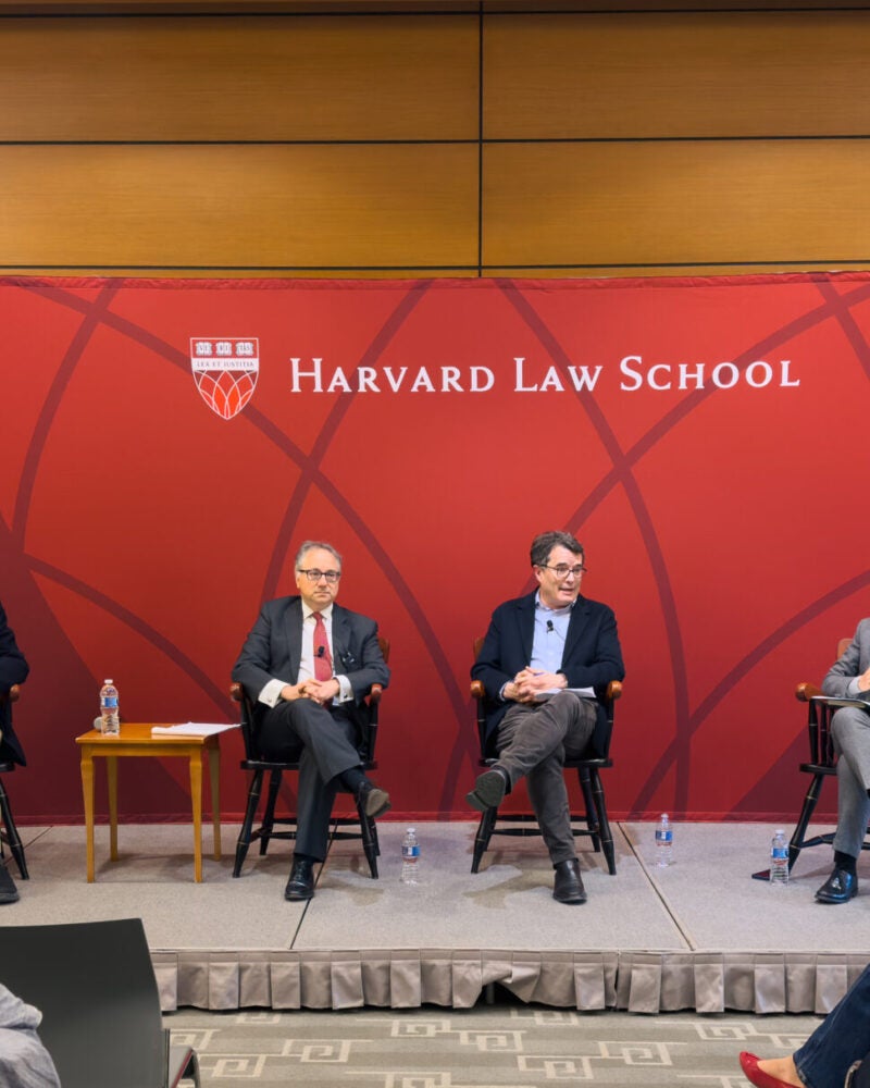 Four people speaking at HLS event.
