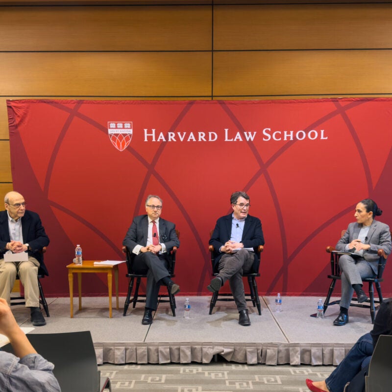 Four people speaking at HLS event.
