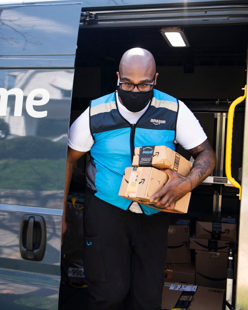 Amazon delivery driver exiting his van.