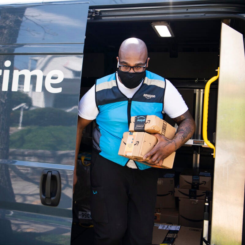 Amazon delivery driver exiting his van.