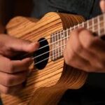 Hand strumming a ukelele