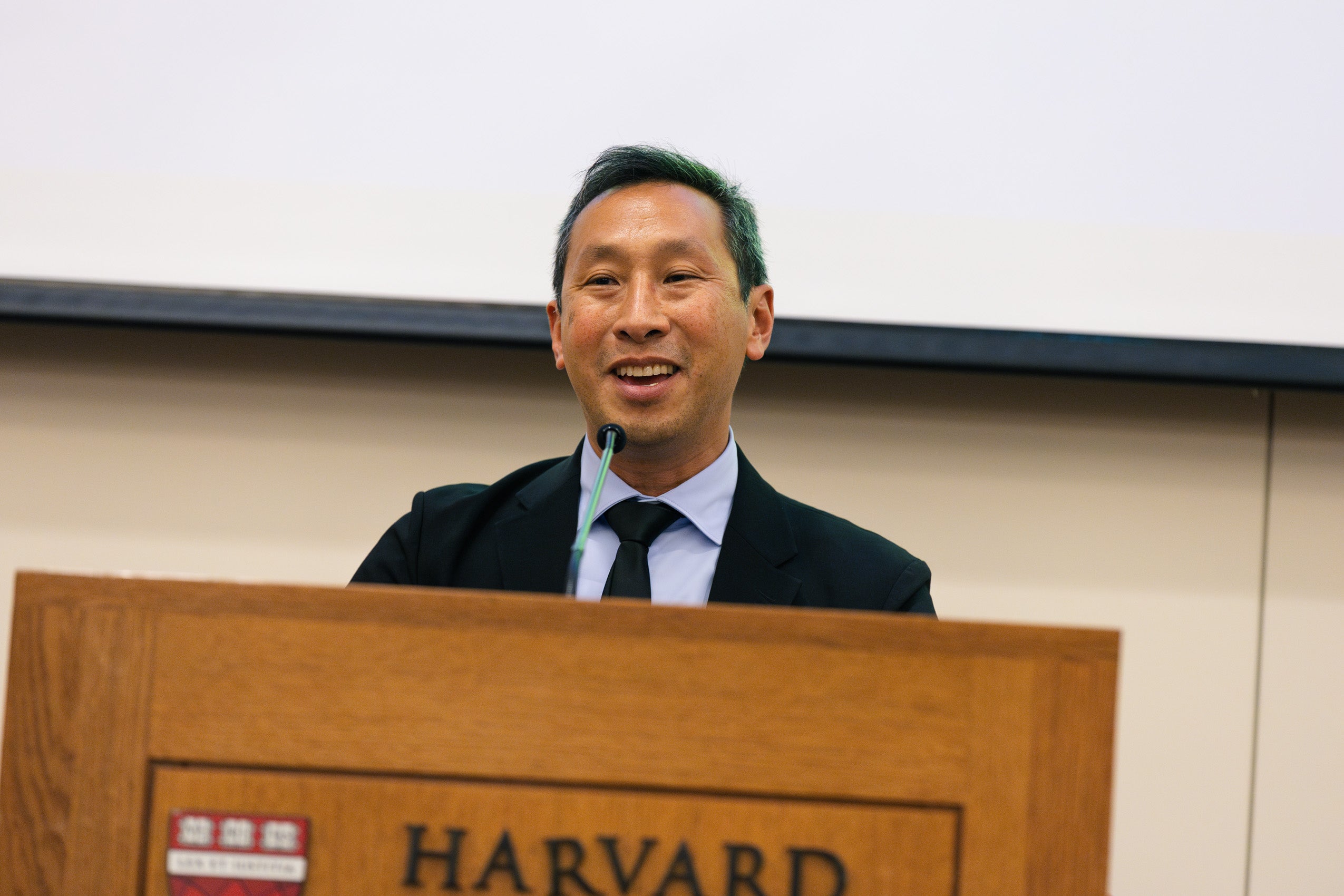 Mark Wu speaking at a podium