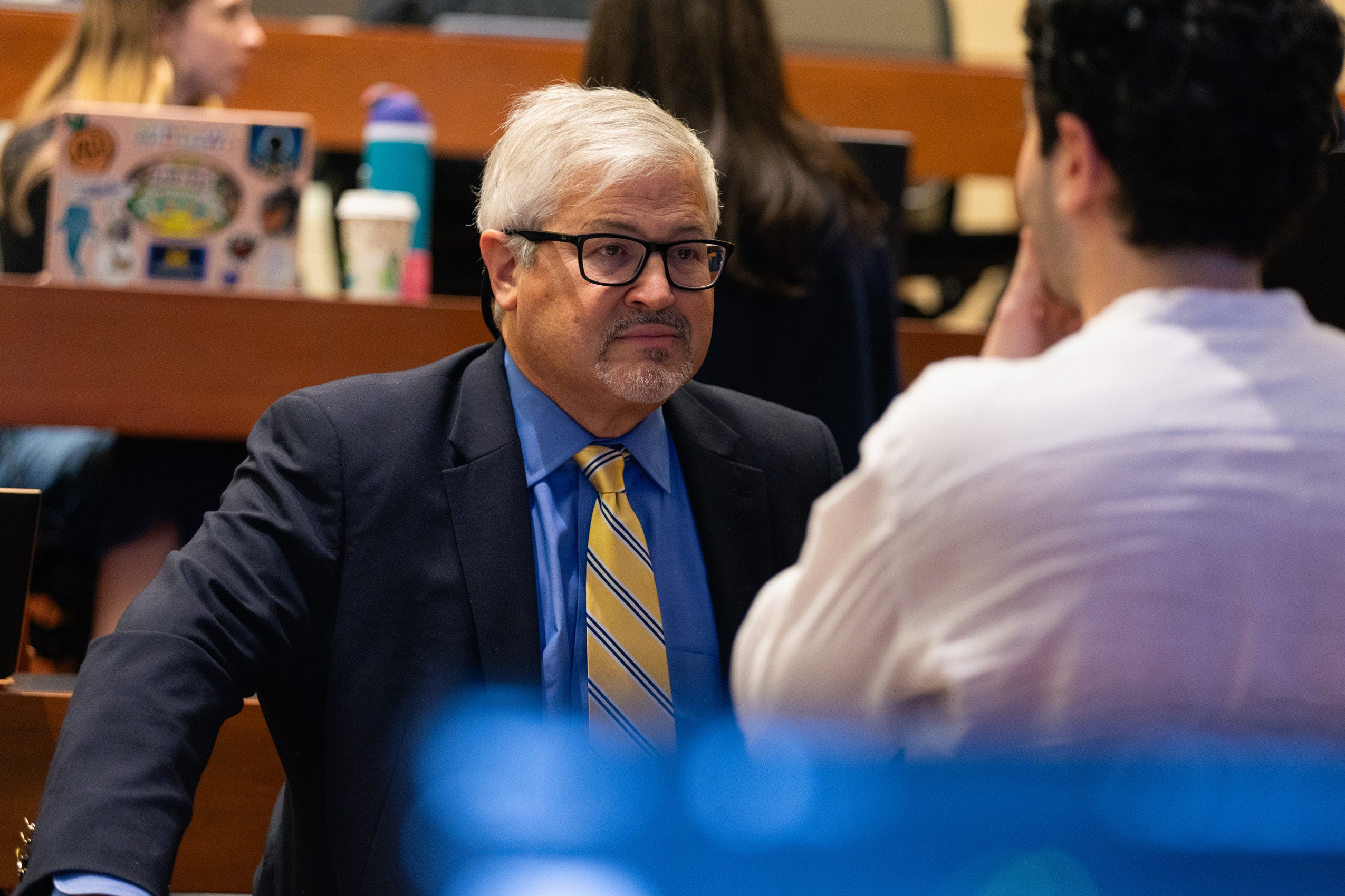 Jack Goldsmith speaks to a student in a classroom.