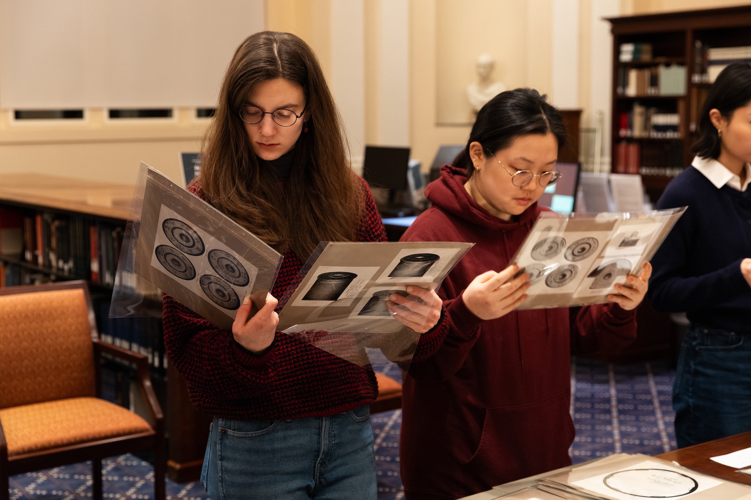 Students examining images of bullets from the Historical & Special Collections.