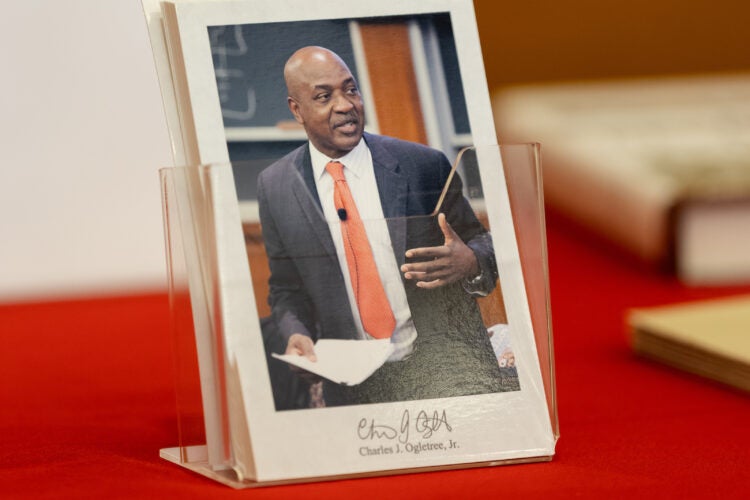 A postcard with a photo of Charles Ogletree.