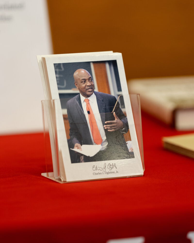 A postcard with a photo of Charles Ogletree.