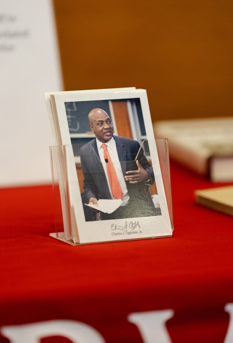 A postcard with a photo of Charles Ogletree.