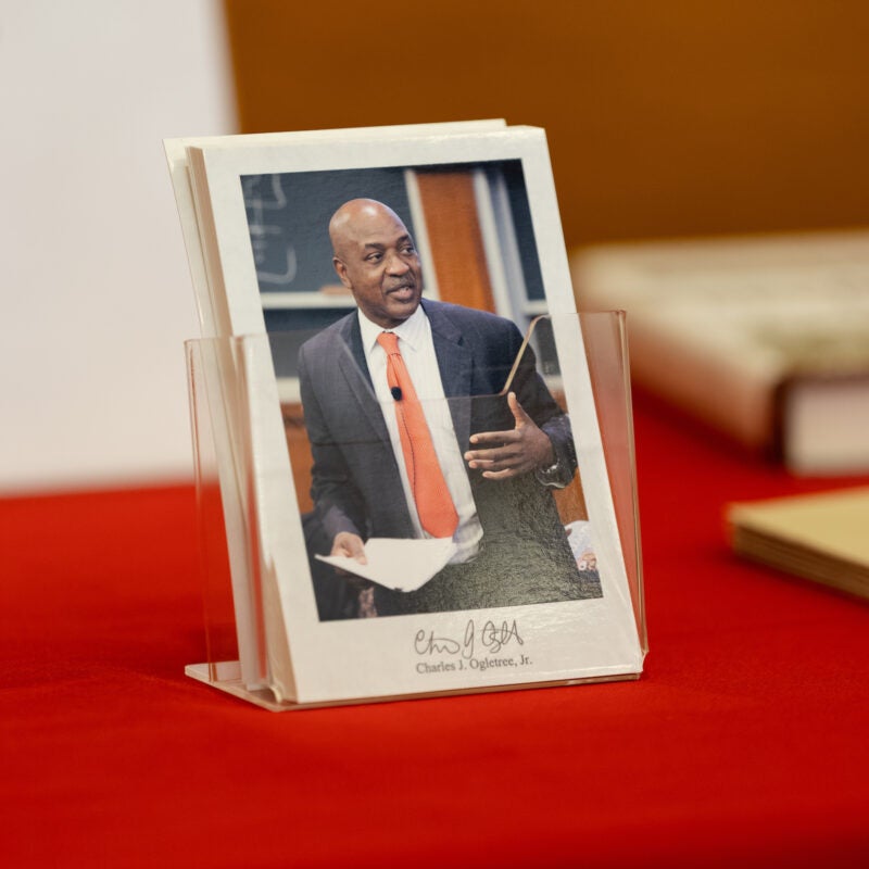 A postcard with a photo of Charles Ogletree.