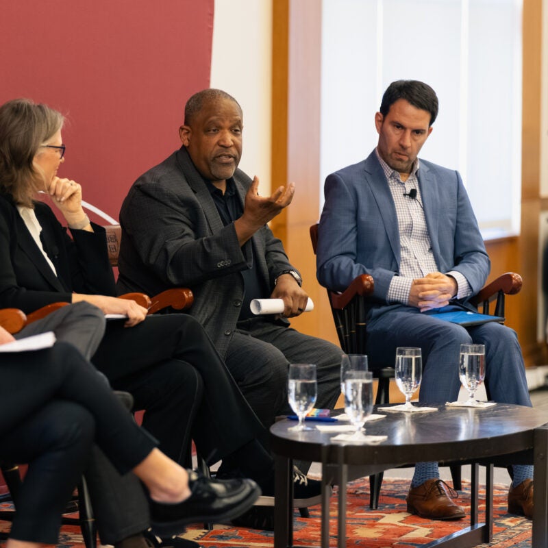 Ronald Sullivan speaks as other panelists listen.