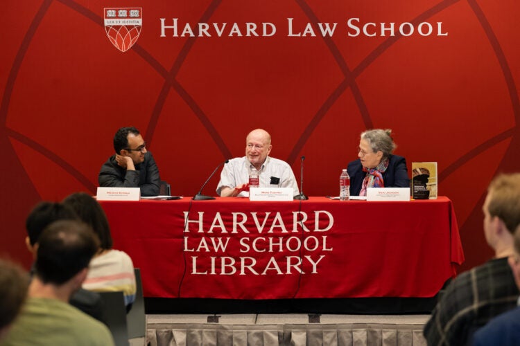 Mark Tushnet speaks while his co-panelists listen.