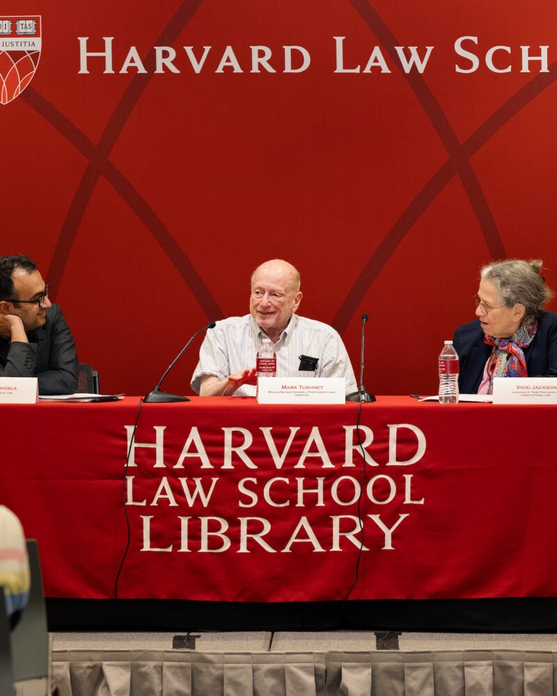 Mark Tushnet speaks while his co-panelists listen.