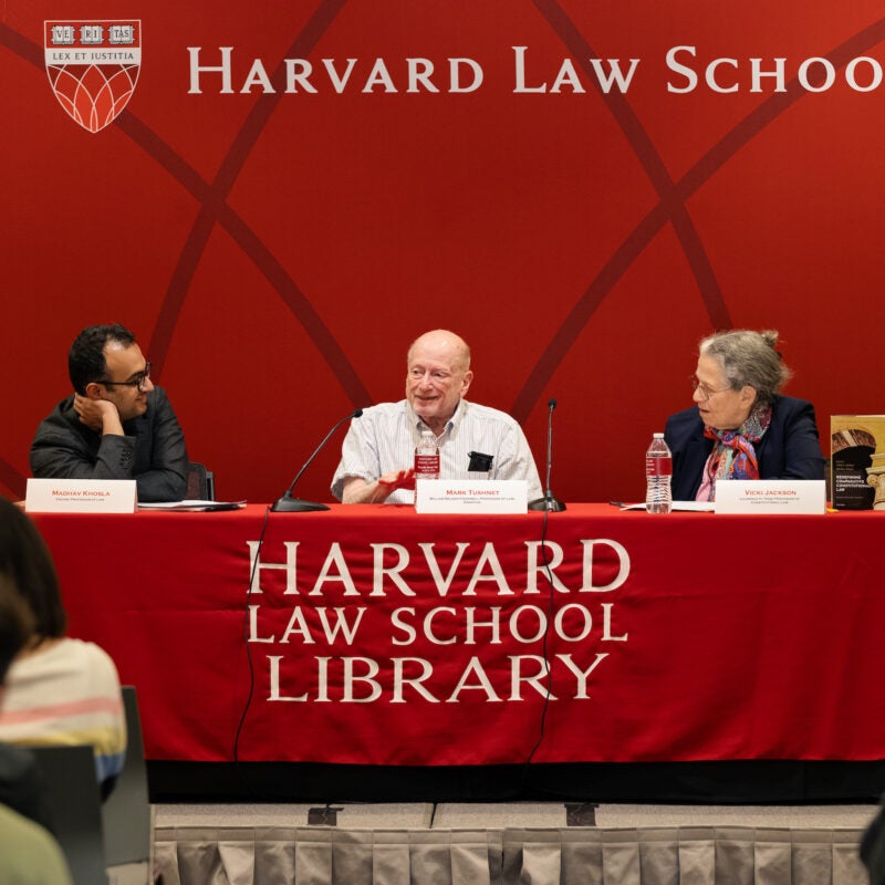 Mark Tushnet speaks while his co-panelists listen.