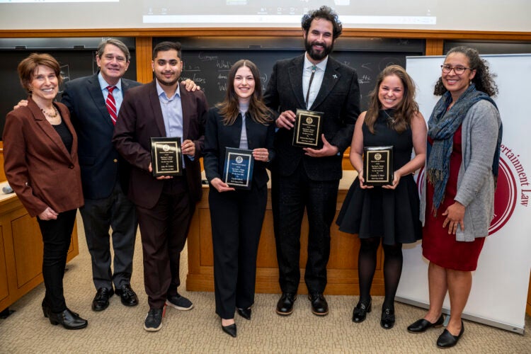 Weiler Award recipients stand holding their awards