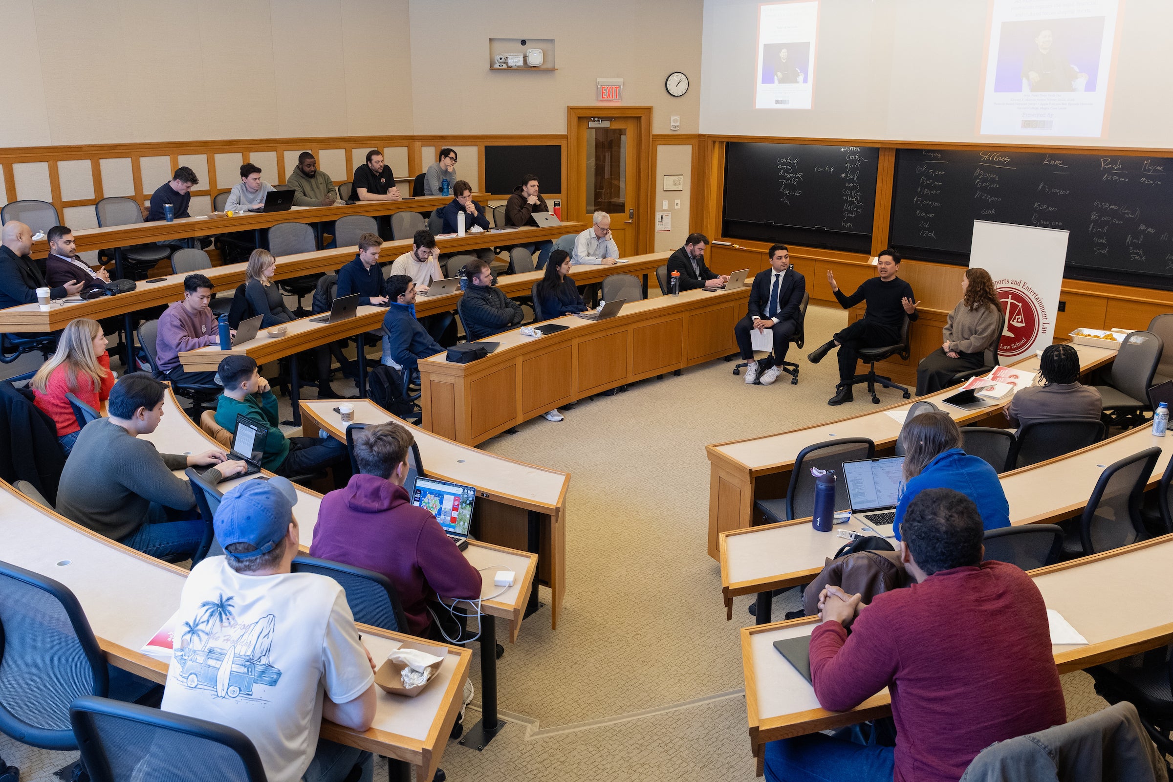 A view from the back of the classroom of Pablo Torre speaking.