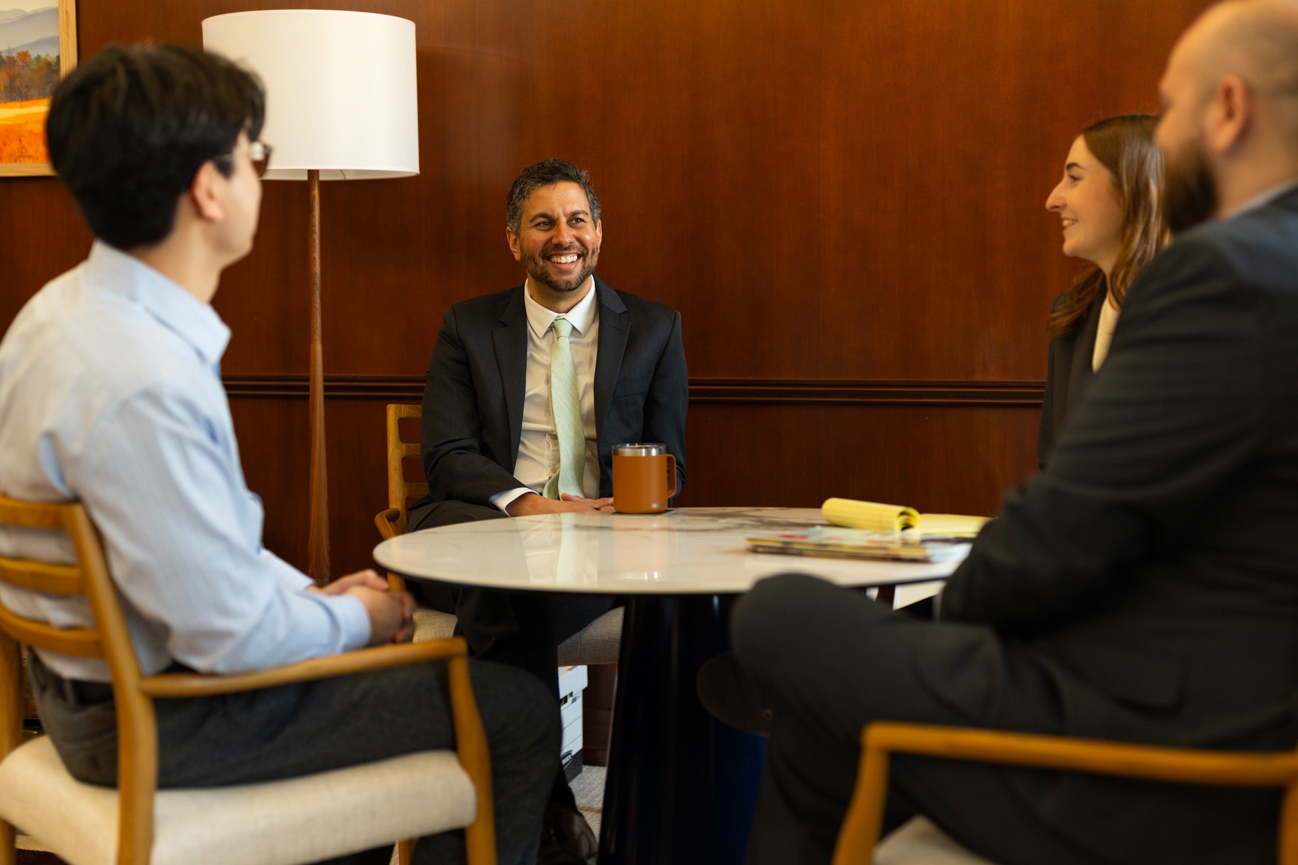 A judge in his chambers meeting with his clerks.