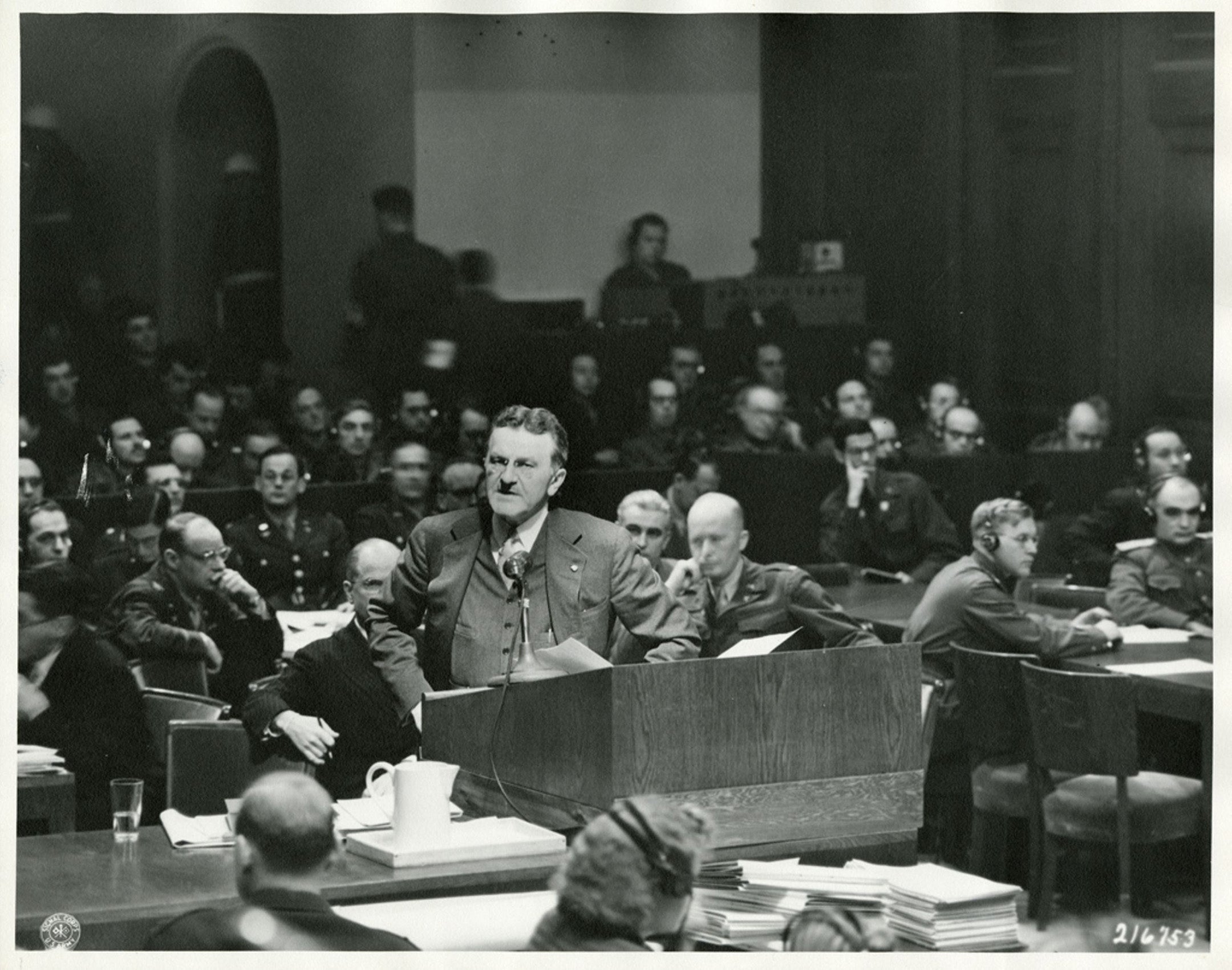 Ralph Albrecht stands at a podium in a courtroom.