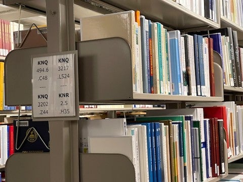 Chinese legal studies books on a library book shelf.