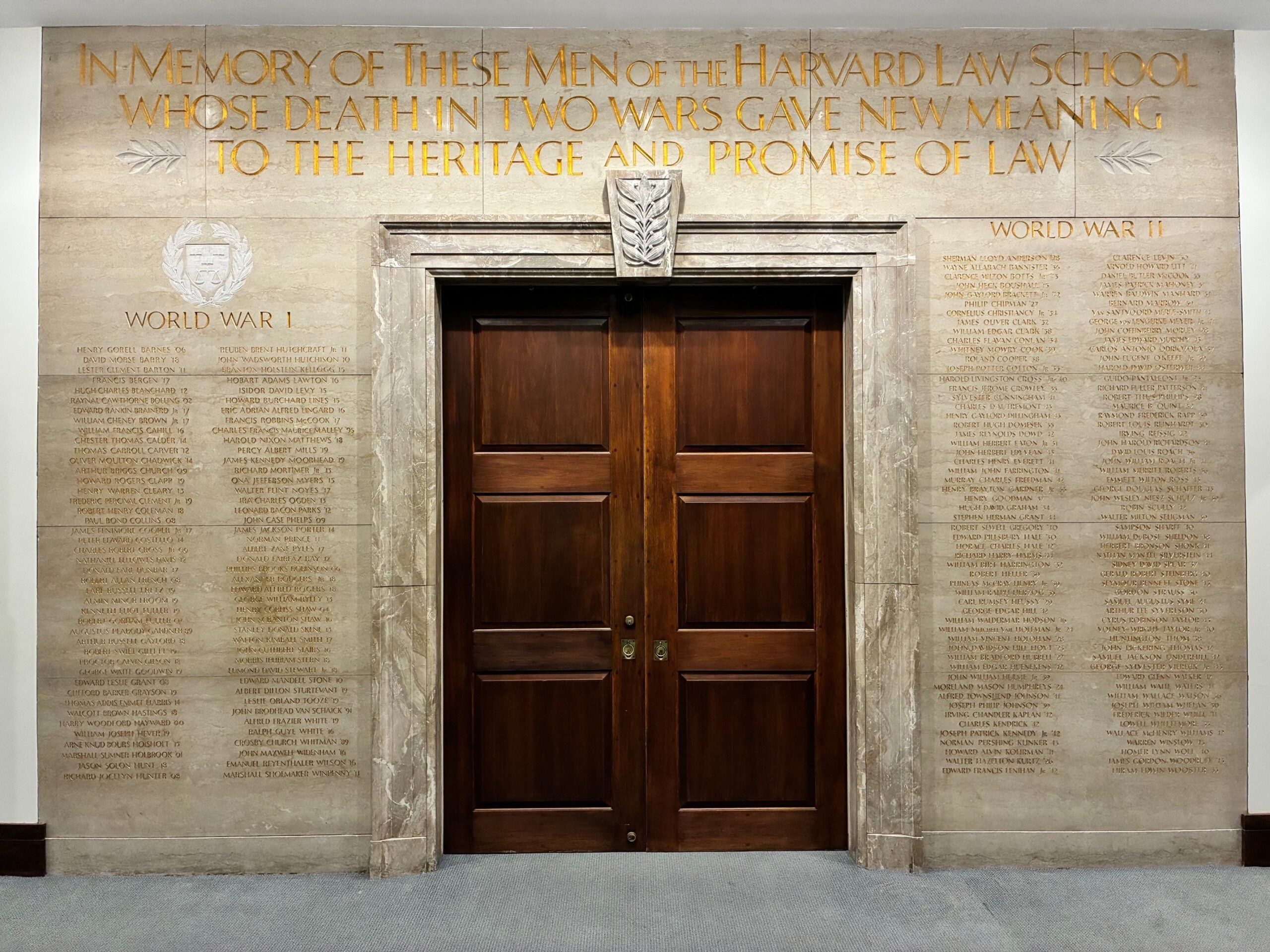 Memorial wall with inscription over names of alumni lost in world war 1 and 2 reads: In memory of these men of the Harvard Law School whose death in two wars gave new meaning to the heritage and promise of law.
