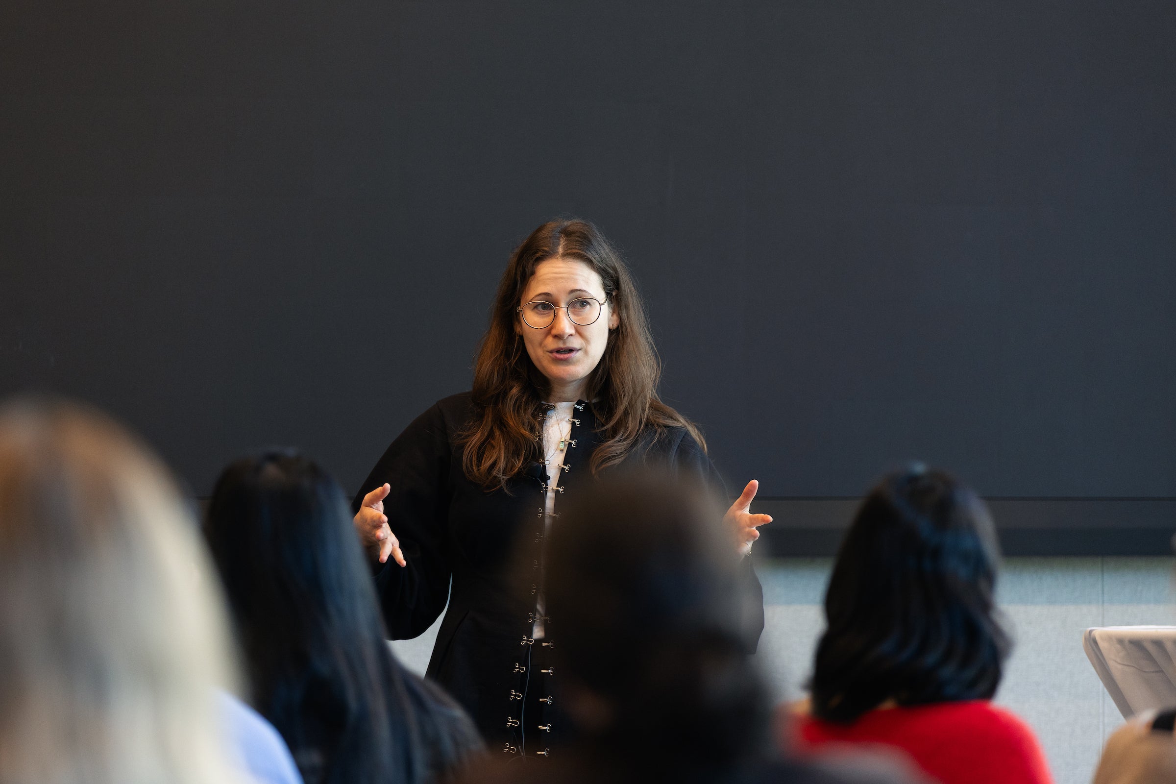 Professor Carmel Shachar speaks to a group of people.