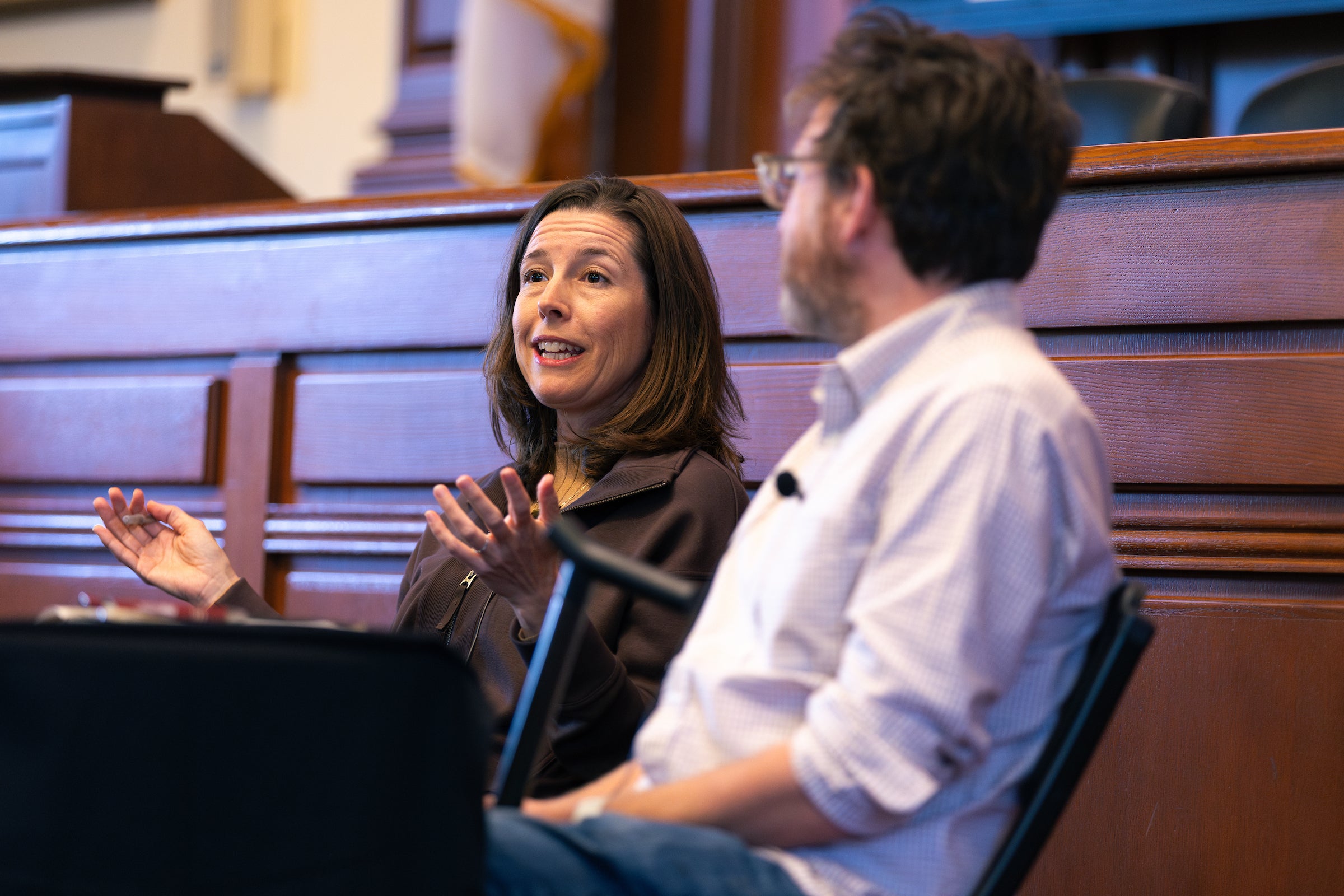 Two panelists speak at an event.