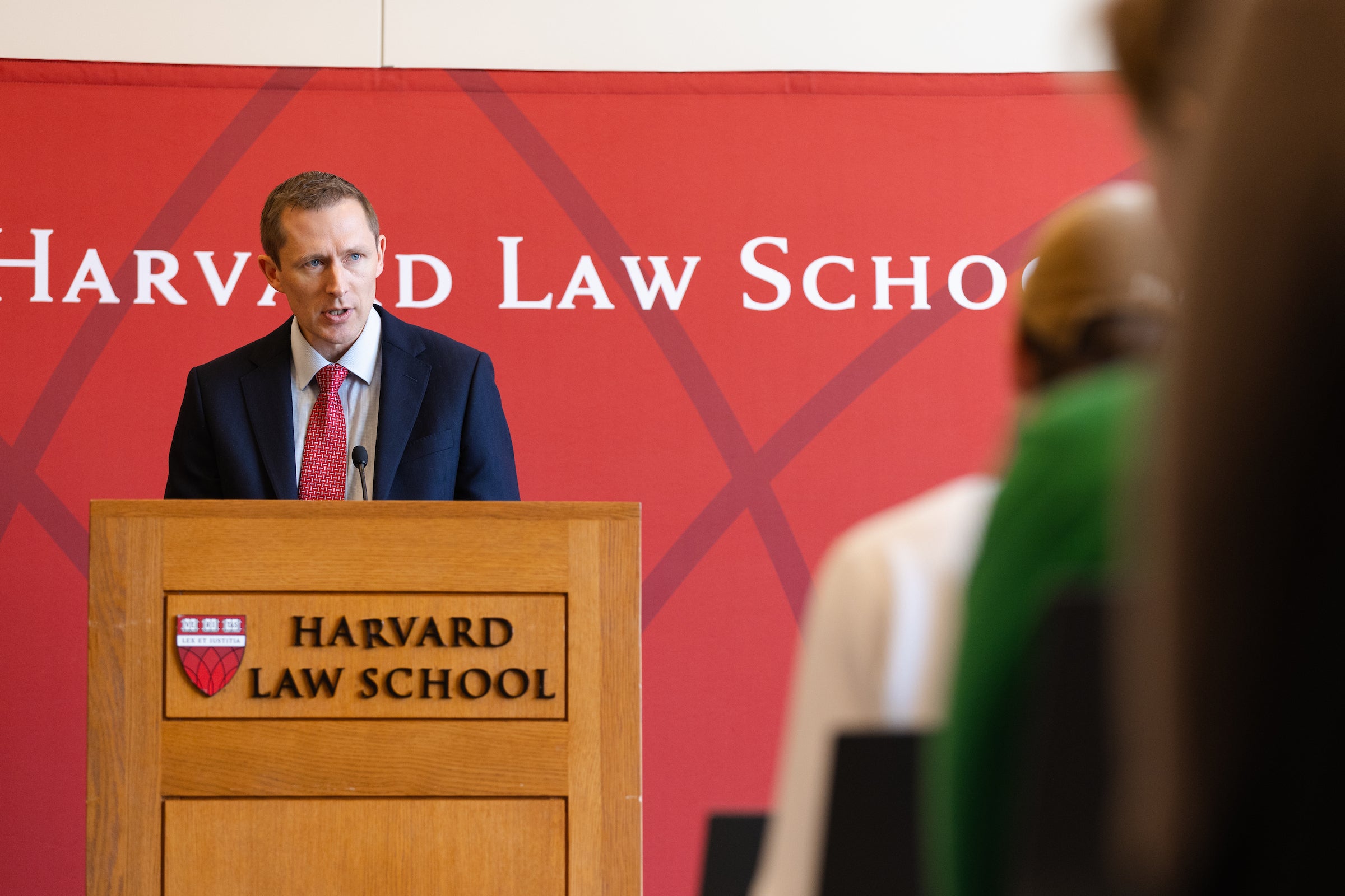 Richard Ekins speaks to a crowd from a podium.