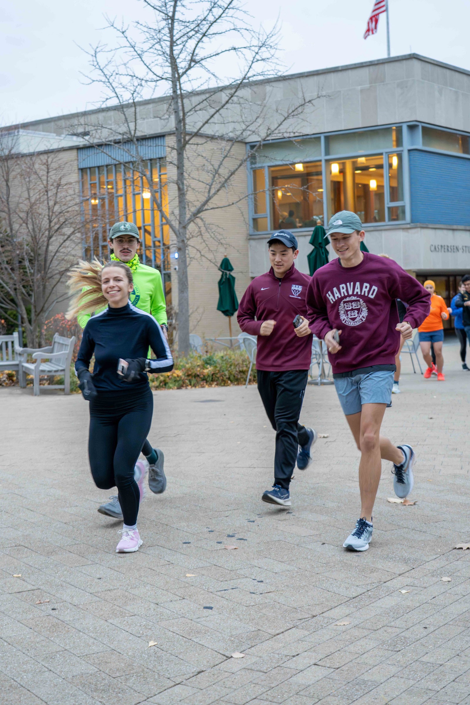 Students run in front of a building.