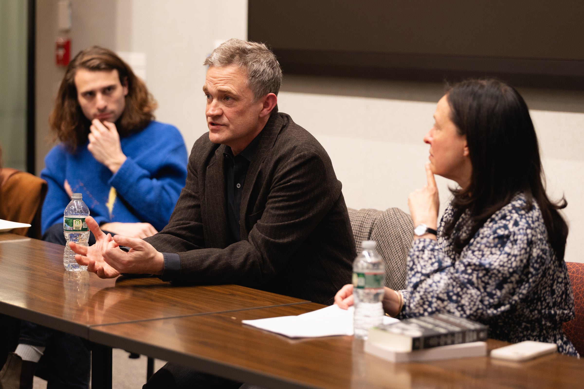 Amy Davidson Sorkin and Patrick Radden Keefe engage in conversation at a conference table.
