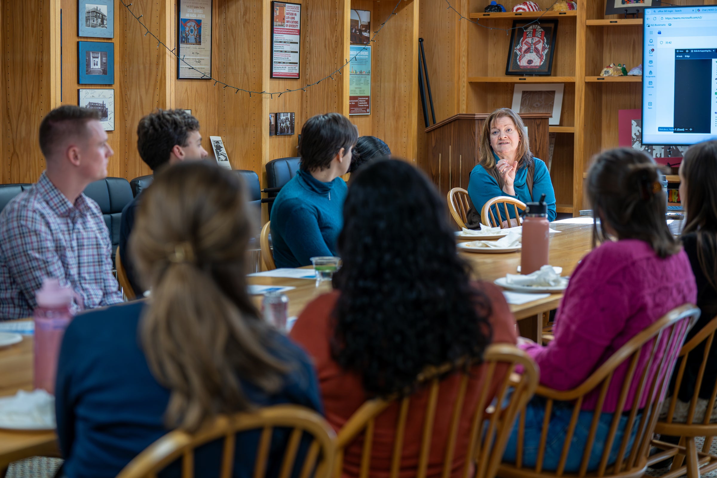 People meet around a conference table.