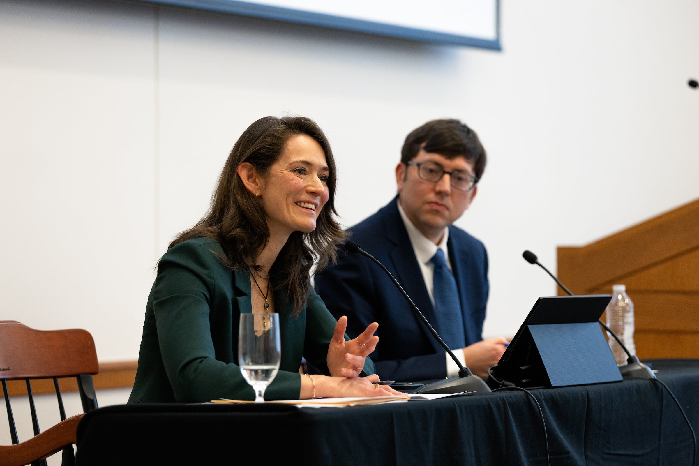 Two people speak on a panel.