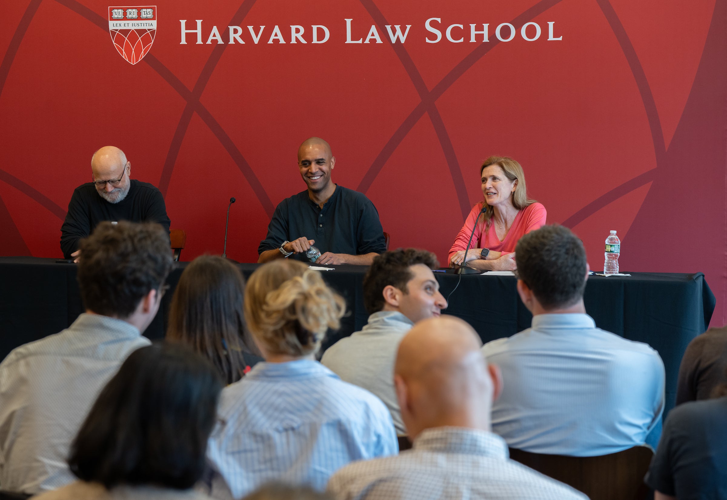 Three professors on a panel speak to an audience.