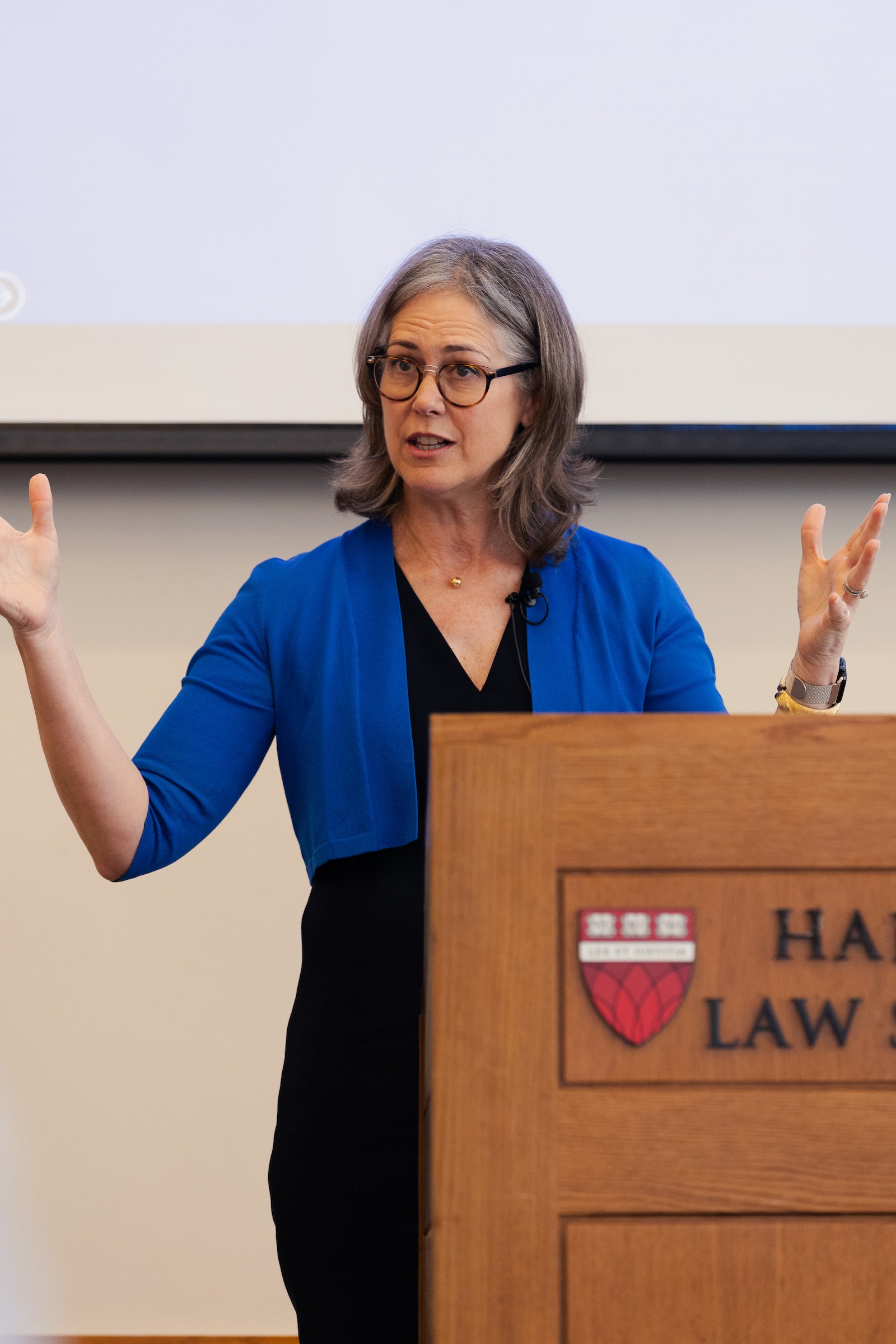 Sheila Heen delivers a talk behind a podium.