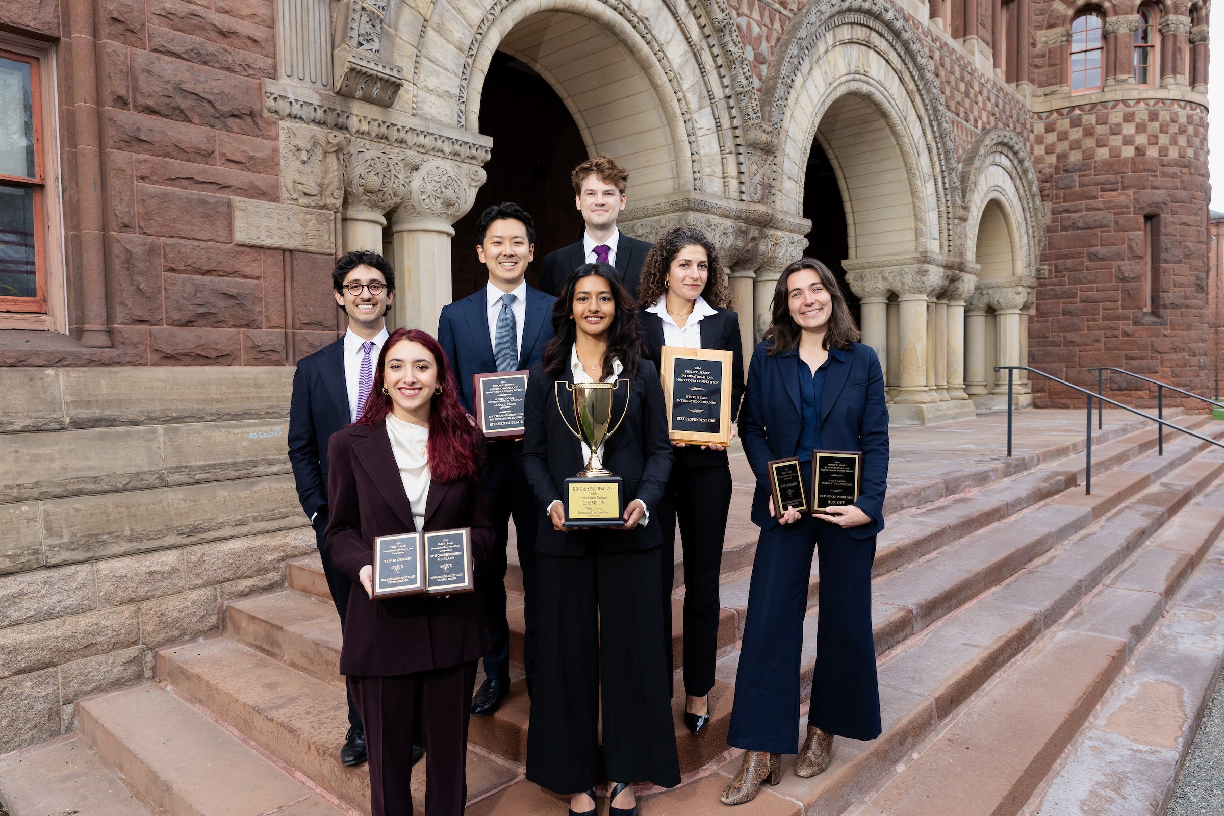 A team of students pose with an award.