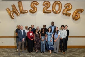 A group of students standing in front of HLS 2026 balloons