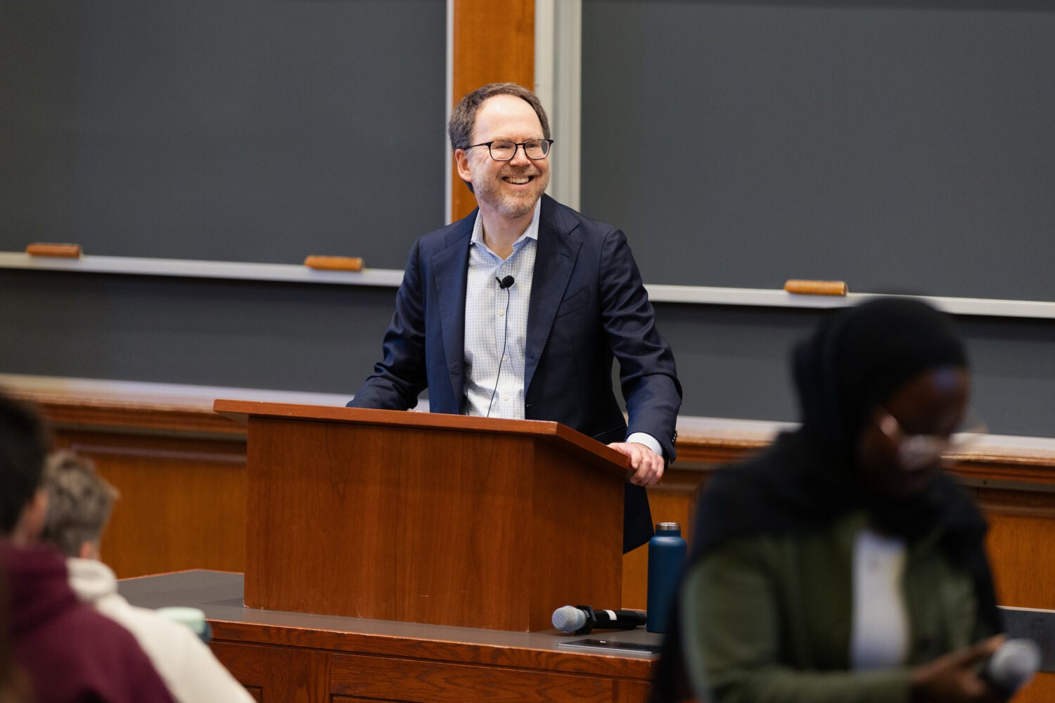 Ben Sachs smiling from behind the podium.
