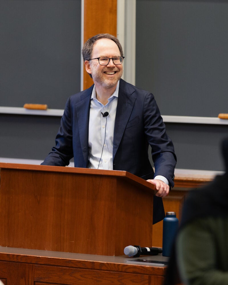 Ben Sachs smiling from behind the podium.