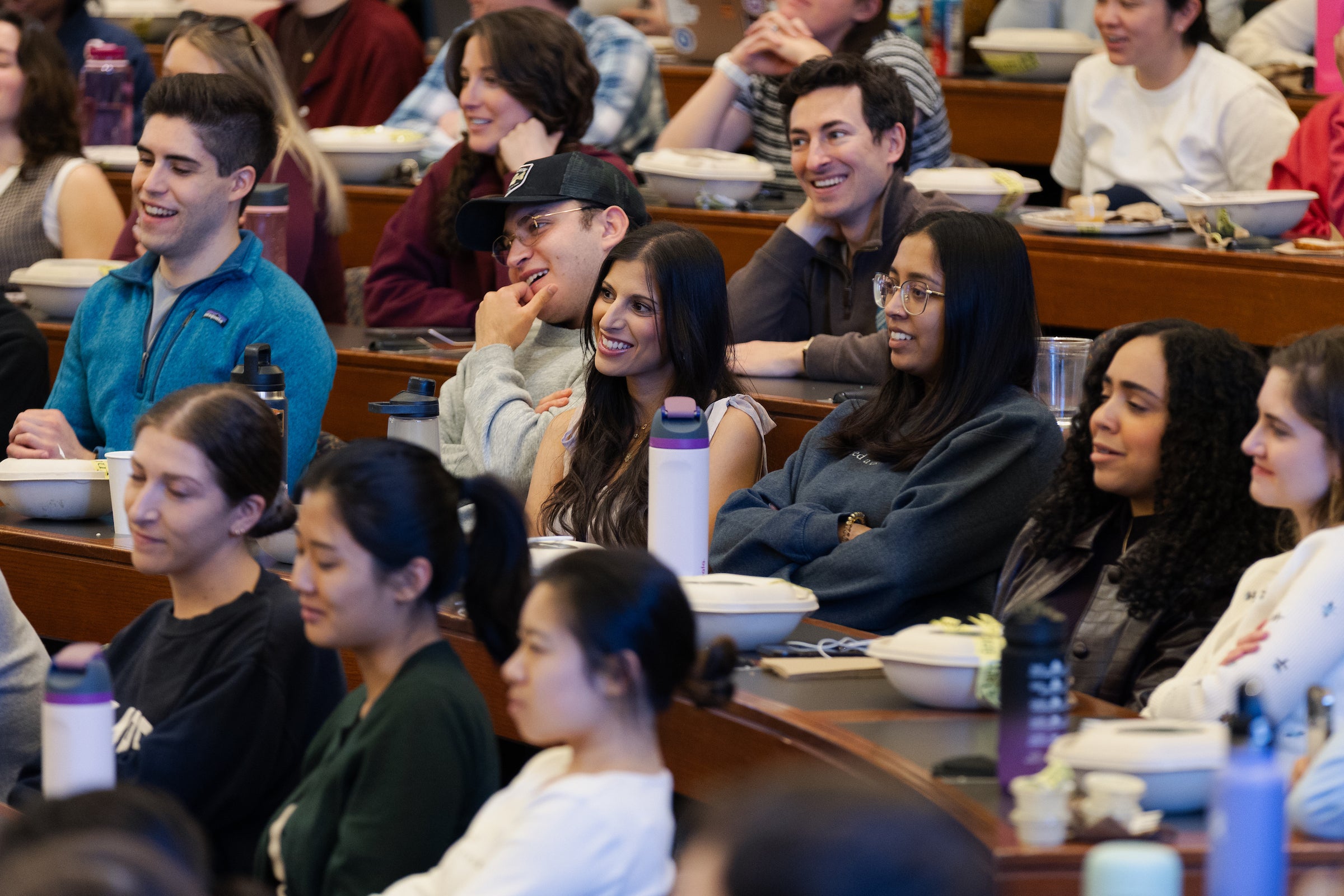 Students smiling in response to Ben Sachs’ Last Lecture.