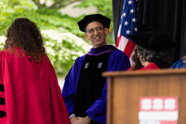 Dean Goldberg converses with Harvard Law Professors onstage during commencement.