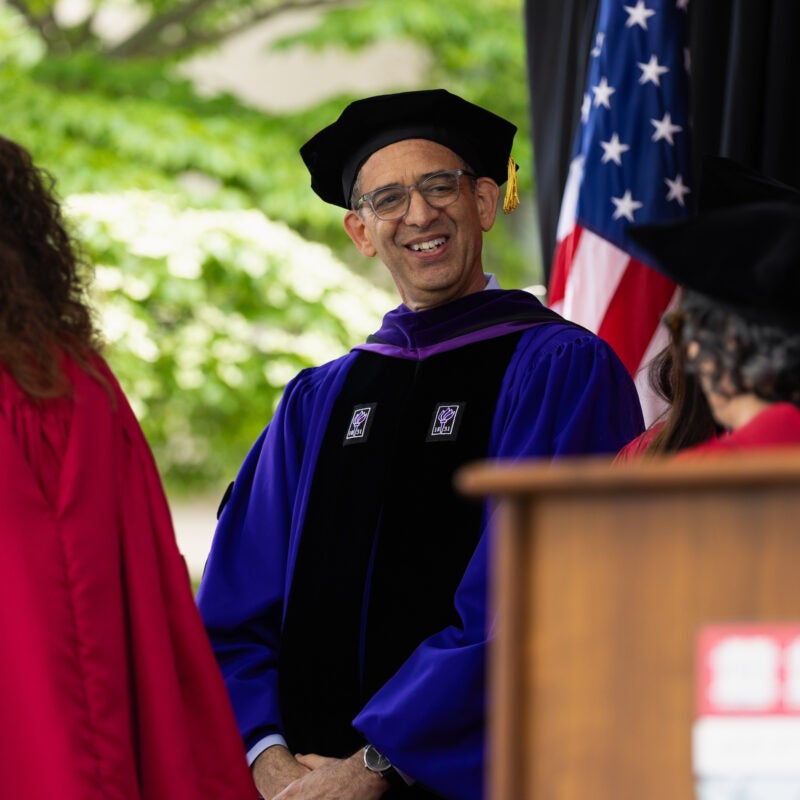 Dean Goldberg converses with Harvard Law Professors onstage during commencement.